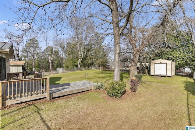 view of yard with a wooden deck and a shed