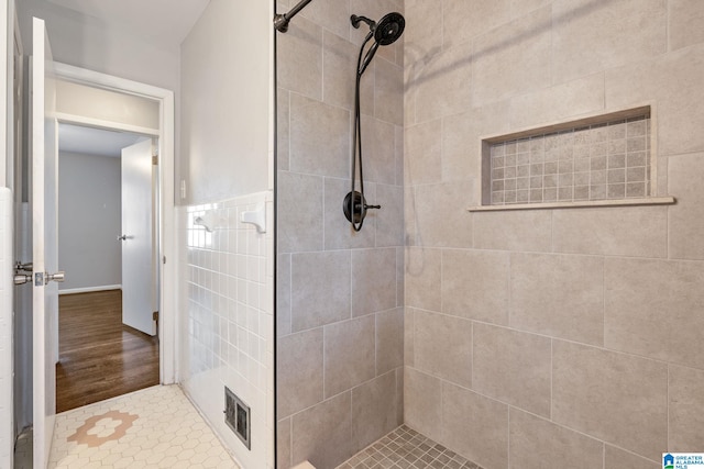 bathroom featuring a tile shower and tile patterned floors