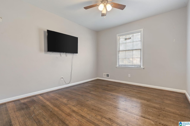 empty room with ceiling fan and dark hardwood / wood-style floors