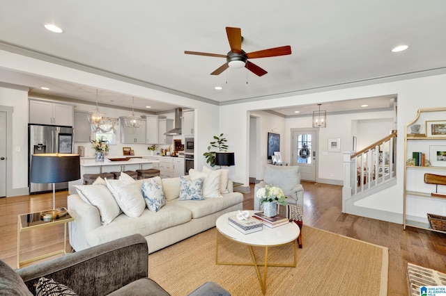 living room featuring ceiling fan and light hardwood / wood-style floors