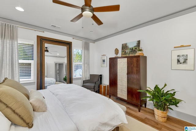 bedroom with ceiling fan and light hardwood / wood-style flooring