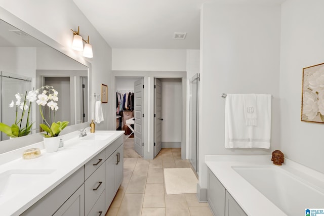 bathroom with plus walk in shower, tile patterned floors, and vanity