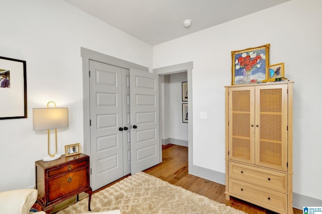 bedroom with light wood-type flooring and a closet