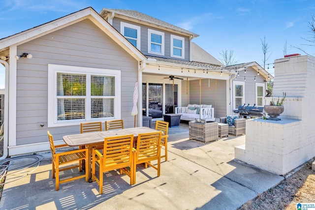 back of house featuring an outdoor living space, a patio area, and ceiling fan