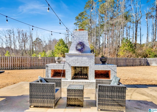 view of patio featuring an outdoor brick fireplace