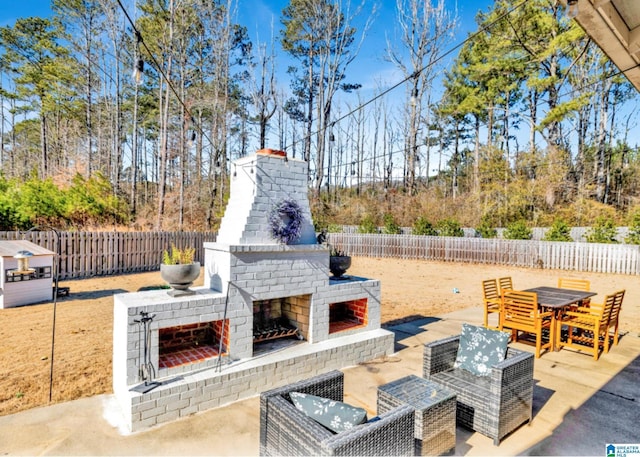 view of patio featuring an outdoor brick fireplace