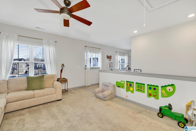 carpeted living room featuring ceiling fan