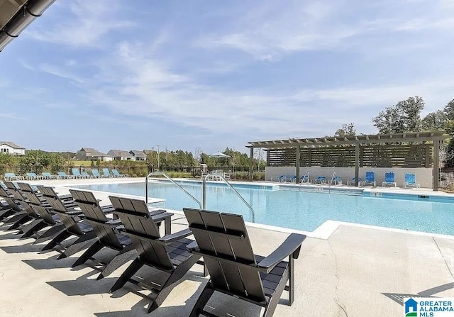 view of pool with a pergola and a patio