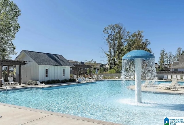 view of pool with pool water feature and a pergola