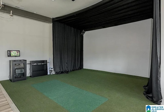 rec room featuring carpet and golf simulator