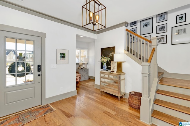 foyer with wood-type flooring and a chandelier