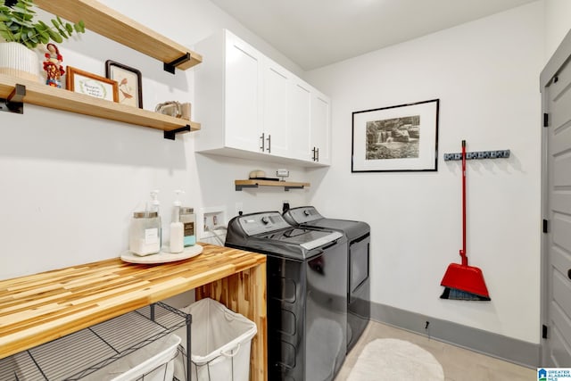 laundry room with washer and clothes dryer and cabinets