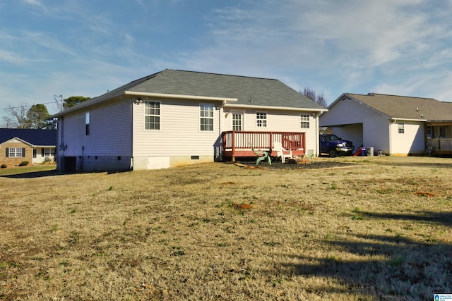 rear view of house featuring a deck and a yard