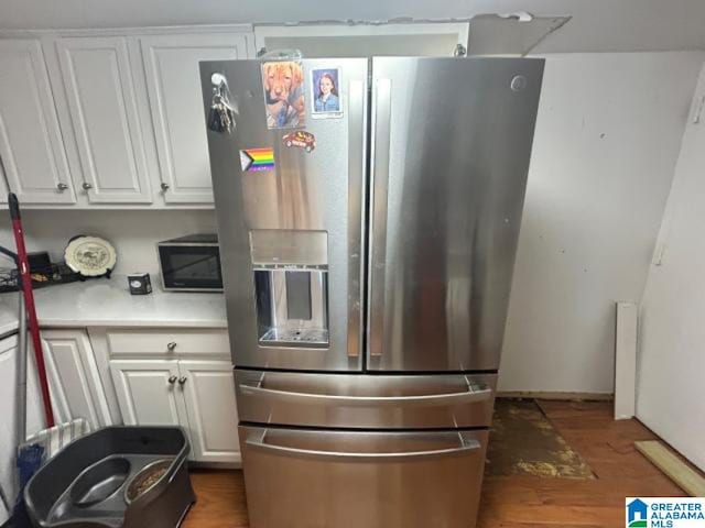 kitchen featuring white cabinets, stainless steel refrigerator with ice dispenser, and dark wood-type flooring