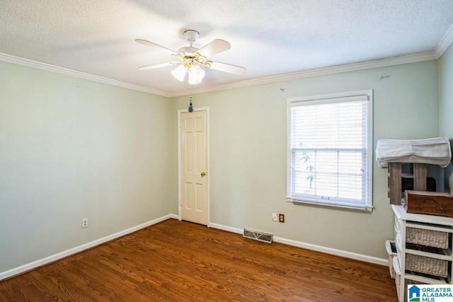 unfurnished room featuring ceiling fan, a textured ceiling, dark hardwood / wood-style flooring, and ornamental molding