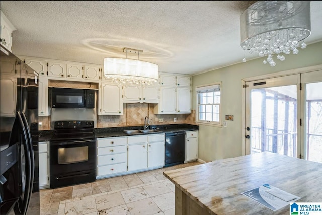 kitchen featuring black appliances, white cabinets, a notable chandelier, and sink