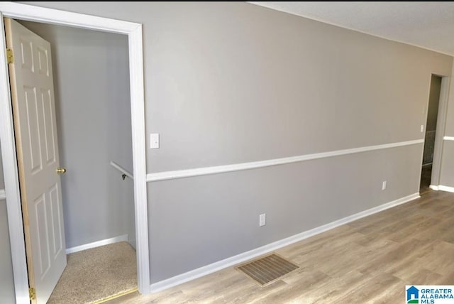 spare room featuring wood-type flooring