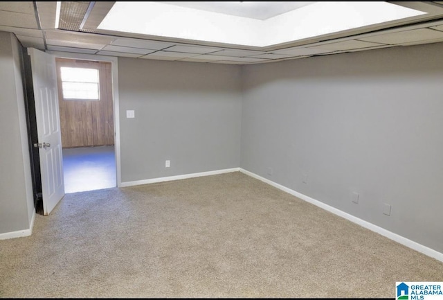 spare room with light carpet and a drop ceiling