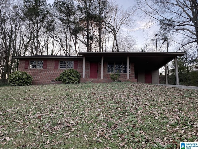 ranch-style house featuring a front yard and a carport