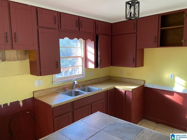 kitchen with sink and light tile patterned flooring