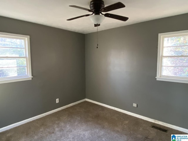 unfurnished room with ceiling fan, a wealth of natural light, and carpet