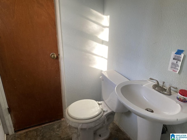 bathroom featuring sink and toilet