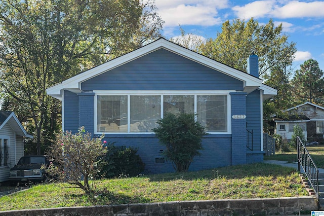 view of side of property with a yard