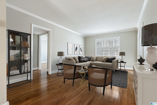 living room with dark wood-type flooring, ornamental molding, and a textured ceiling