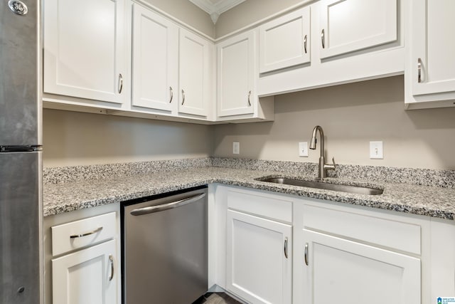 kitchen with sink, crown molding, white cabinetry, light stone countertops, and stainless steel appliances