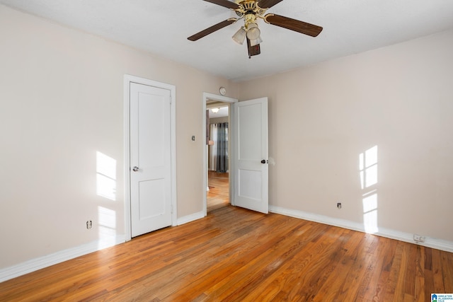 empty room featuring ceiling fan and hardwood / wood-style flooring