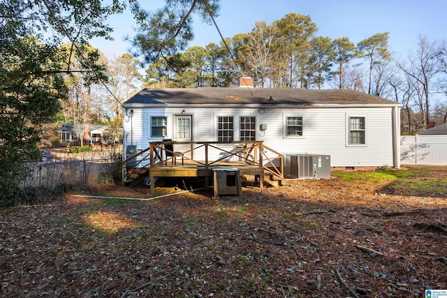 rear view of property with central air condition unit and a deck