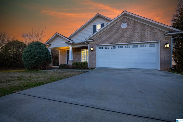 view of front of house featuring concrete driveway, brick siding, and an attached garage