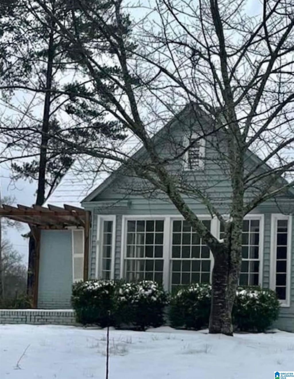 view of snowy exterior with a pergola