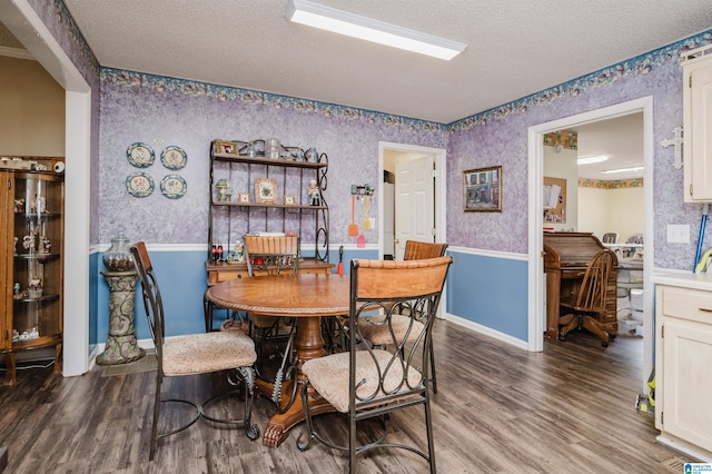 dining room with hardwood / wood-style flooring and a textured ceiling