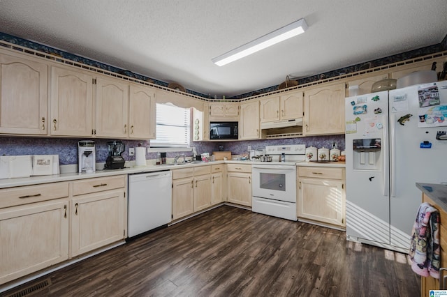 kitchen featuring a textured ceiling, sink, dark hardwood / wood-style floors, and white appliances