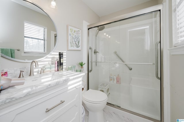 bathroom with toilet, walk in shower, and vanity