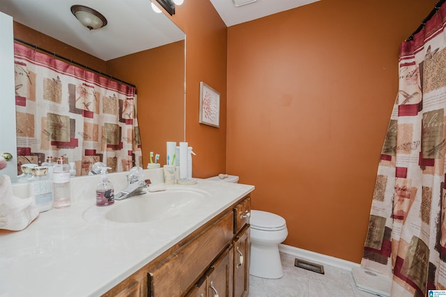 bathroom with toilet, tile patterned floors, and vanity