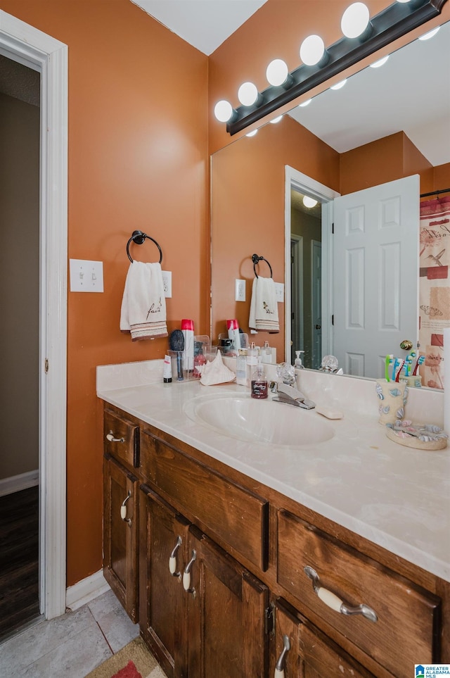 bathroom featuring tile patterned flooring and vanity