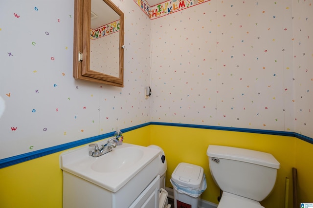 bathroom with toilet and vanity