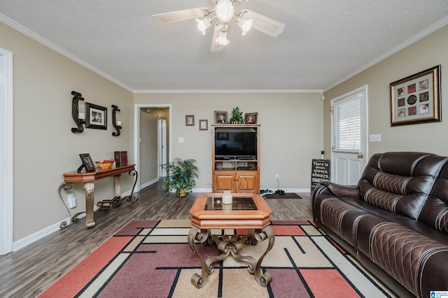 living room featuring a textured ceiling, dark hardwood / wood-style flooring, and ornamental molding