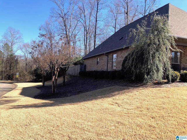 view of side of home featuring a yard