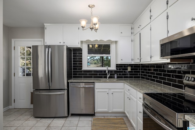 kitchen featuring sink, light tile patterned floors, white cabinets, and stainless steel appliances