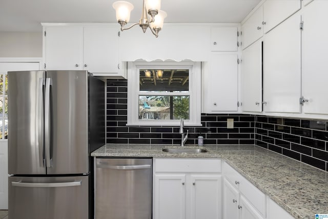 kitchen with white cabinets, appliances with stainless steel finishes, and sink