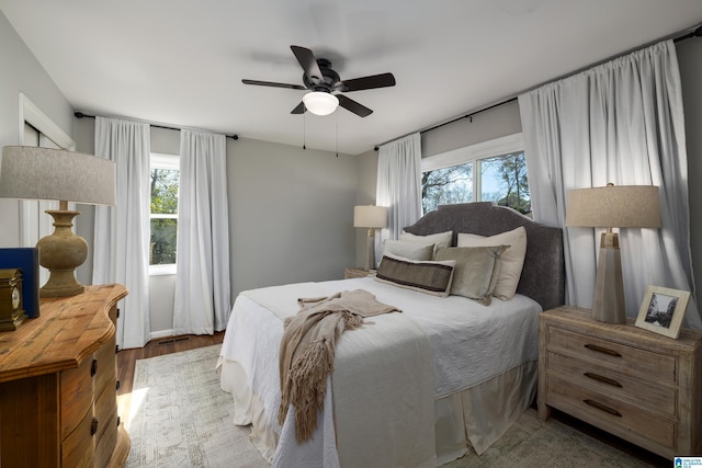 bedroom with ceiling fan and wood-type flooring