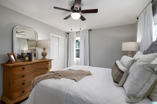 bedroom with ceiling fan and a closet