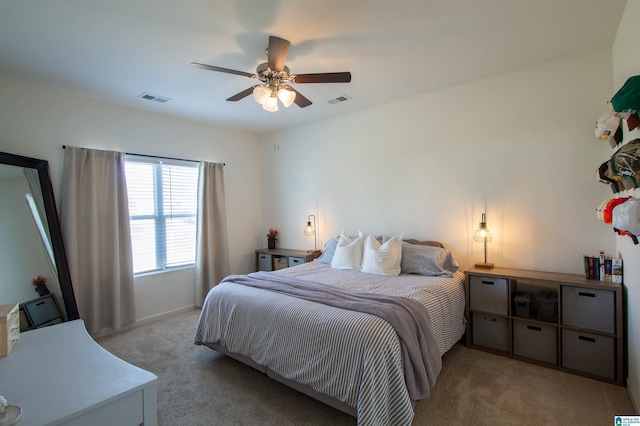 bedroom featuring light carpet and ceiling fan