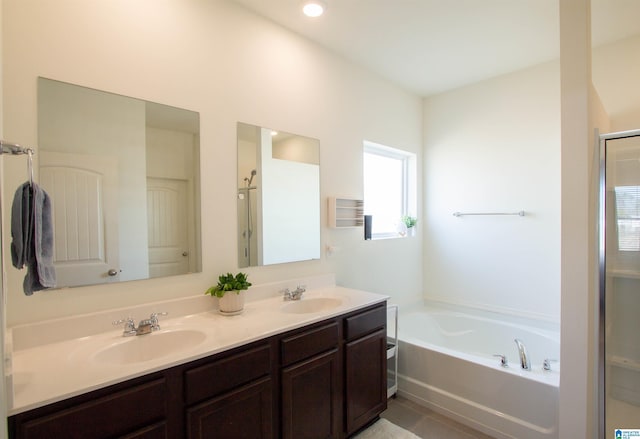 bathroom with tile patterned flooring, shower with separate bathtub, and vanity