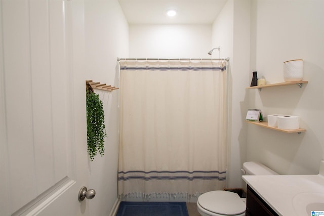 bathroom with vanity, walk in shower, and toilet