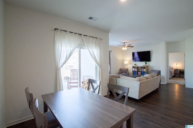 dining space with dark wood-type flooring and ceiling fan