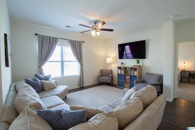 living room with dark wood-type flooring and ceiling fan